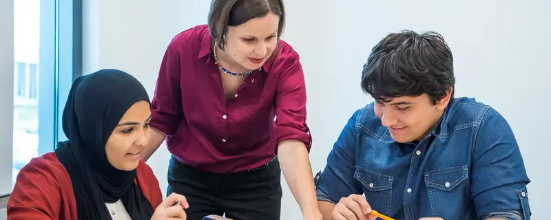 Teacher and students working together in class