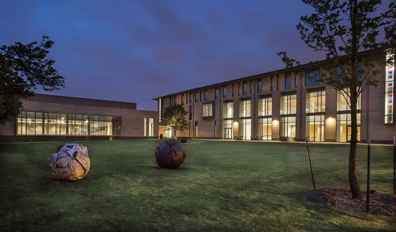 Academic building and lawn at dusk