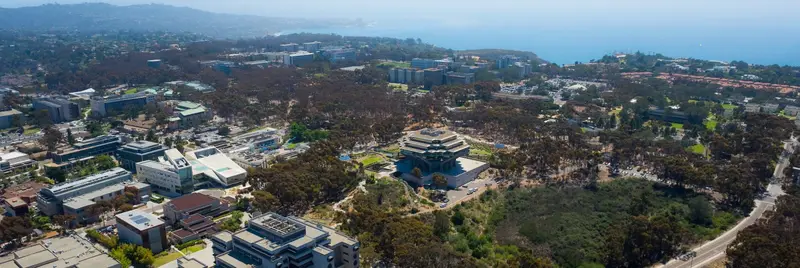 Aerial view of campus buildings and the nearby coastline