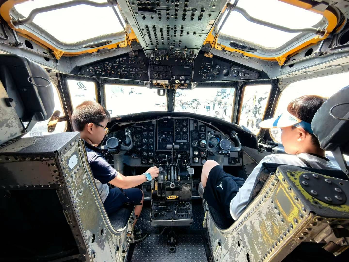 Children exploring the cockpit of an aircraft on display