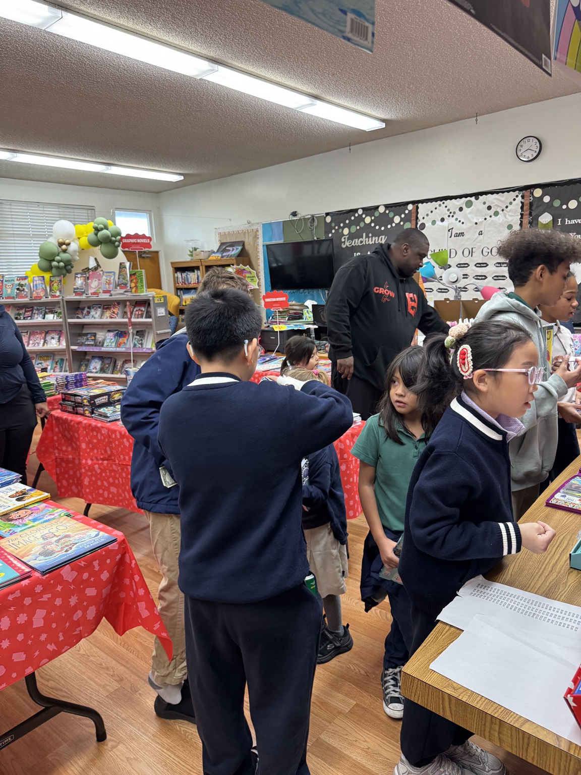 Children exploring books at a school reading activity