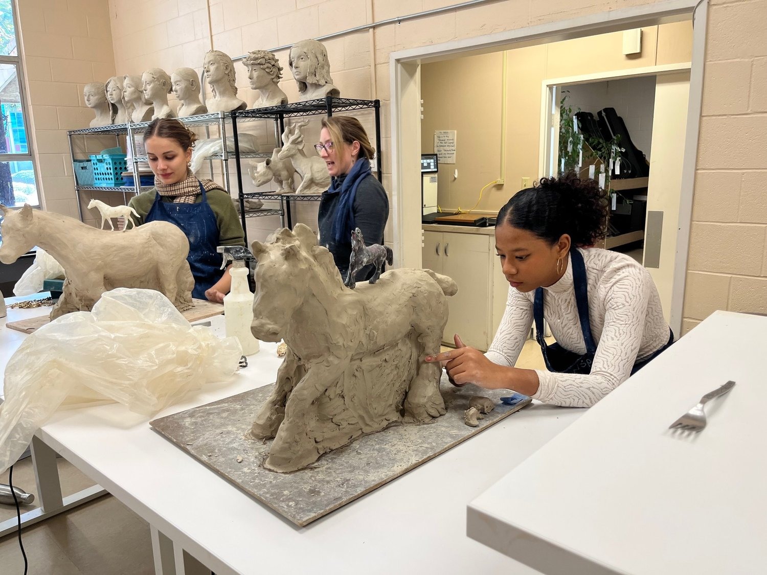 Students working on clay sculptures