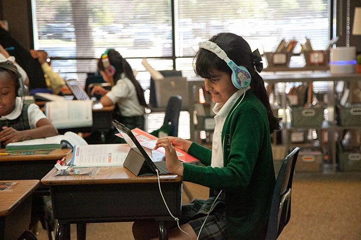 A student uses a tablet during classroom learning