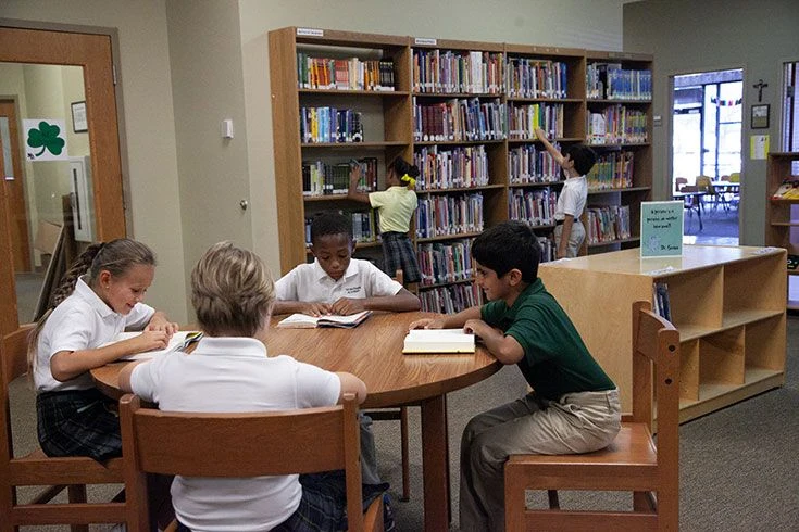 Students read and talk in the school library