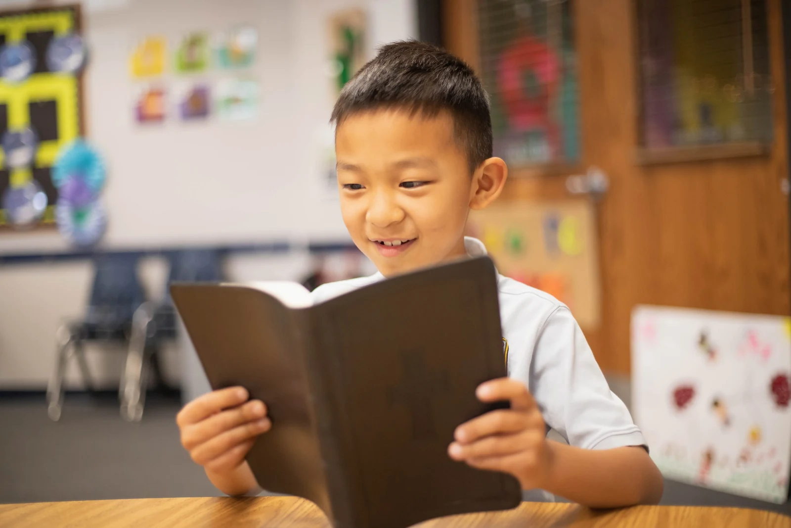 A student reading in the classroom