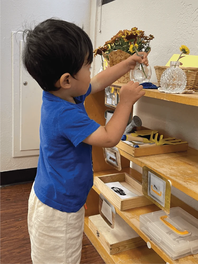 A young child practises a practical-life task