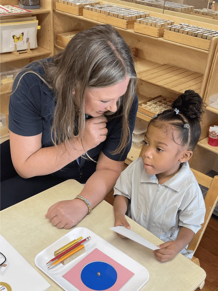 A teacher guides work with learning materials
