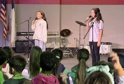 Student singing during school chapel