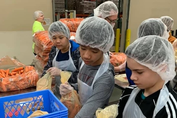Students sorting supplies during a service activity