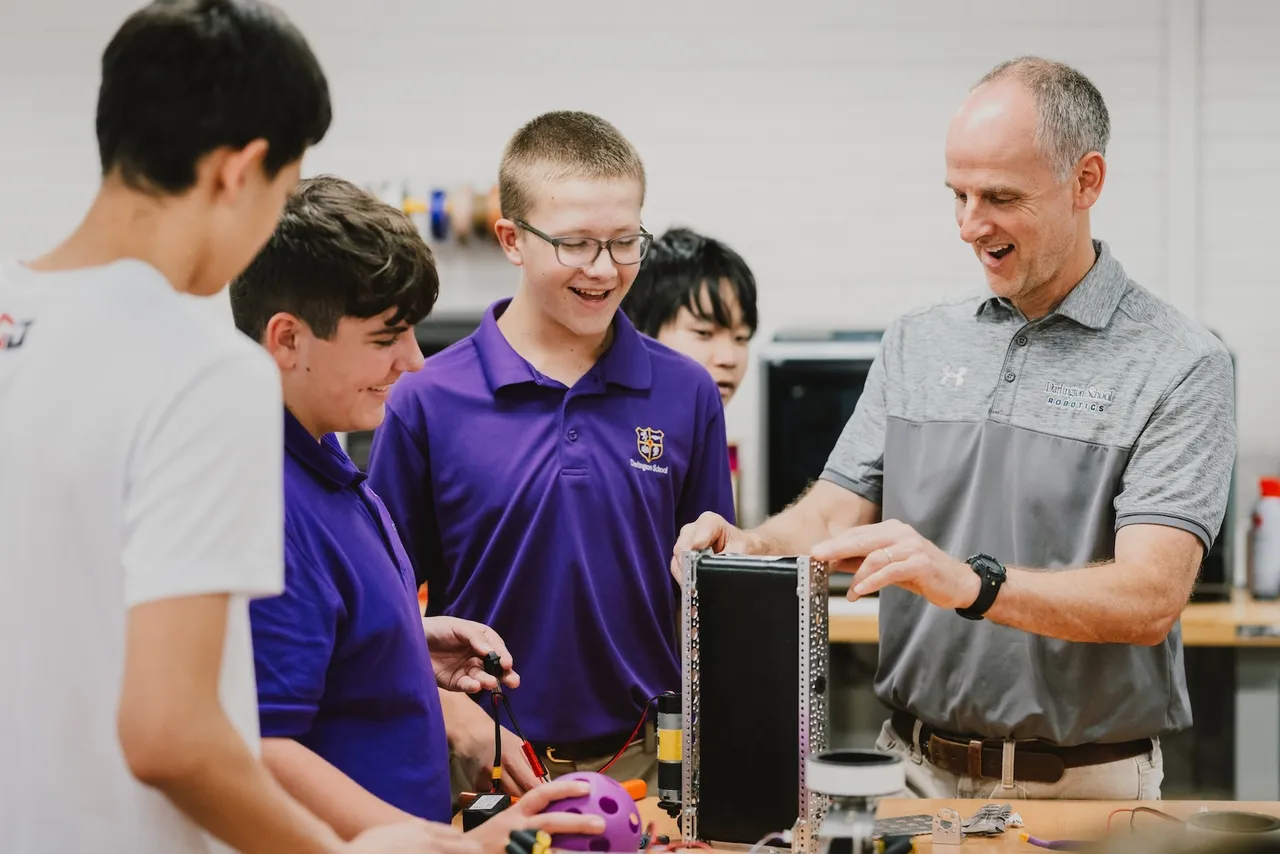 Students and teacher exploring robotics