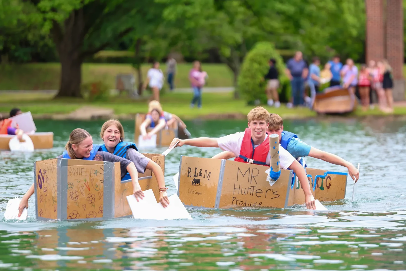 Handmade cardboard-boat activity on the lake