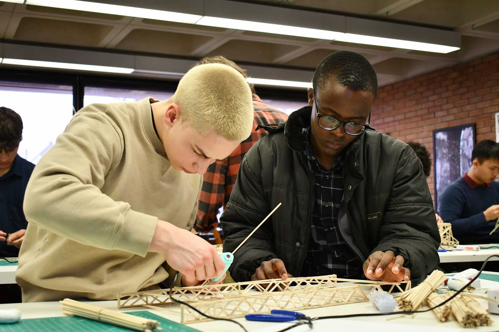 Students building a structural model together