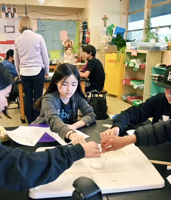 Students collaborating on a classroom experiment