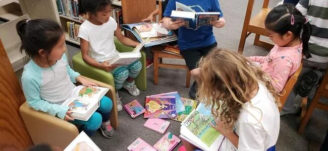 Younger pupils reading together