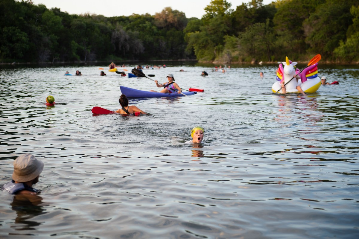 A group takes part in a supervised lake swimming activity