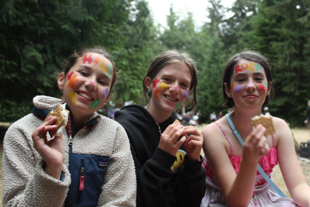 Campers enjoy s’mores together outdoors
