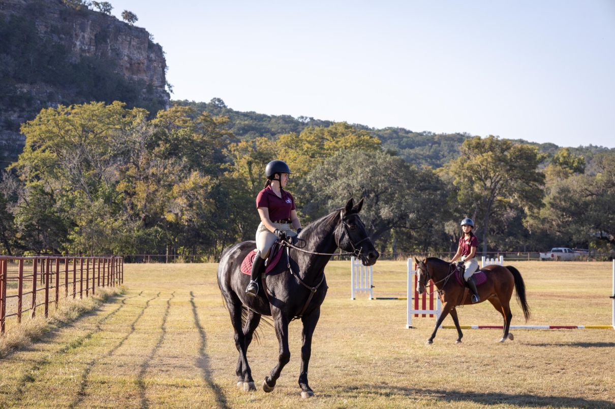 The riding field below the Camp Stewart bluff, pictured during Schreiner University equestrian training.
