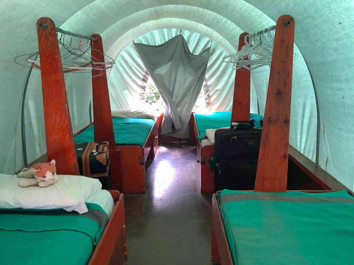 Cheley Family Camp: beds and storage inside a covered wagon.