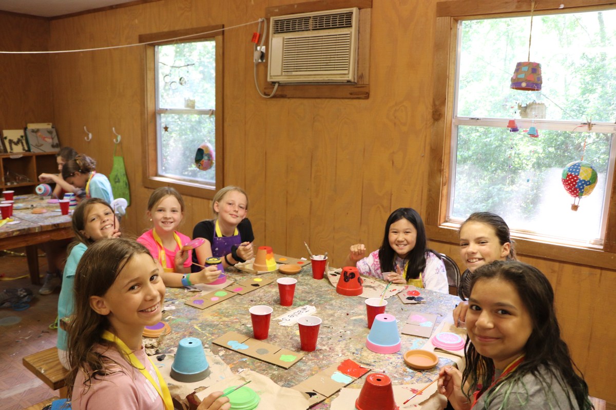 Campers gather around a table for a craft activity