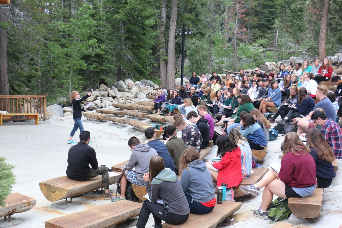 Gold Arrow Camp: staff attend pre-session training at the outdoor campfire area in 2019.