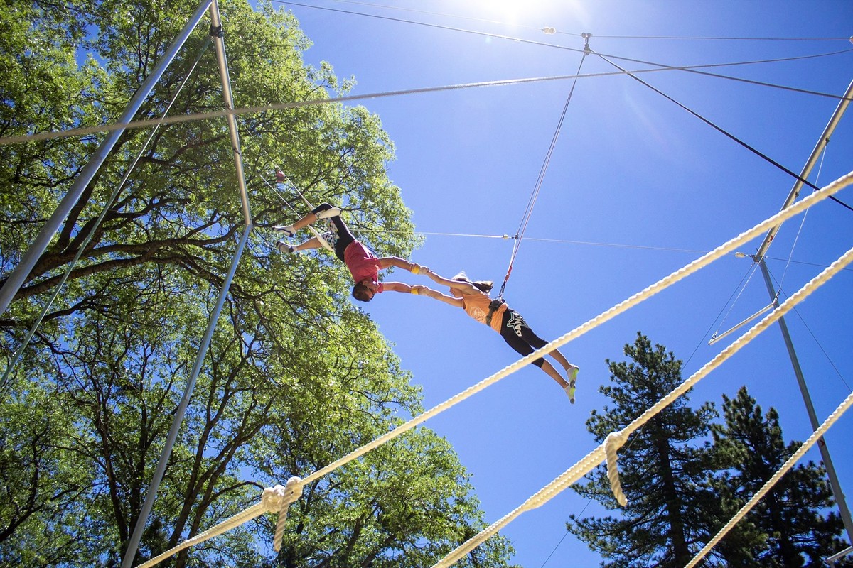 Past Pali trapeze activity: an aerial maneuver above the safety rig