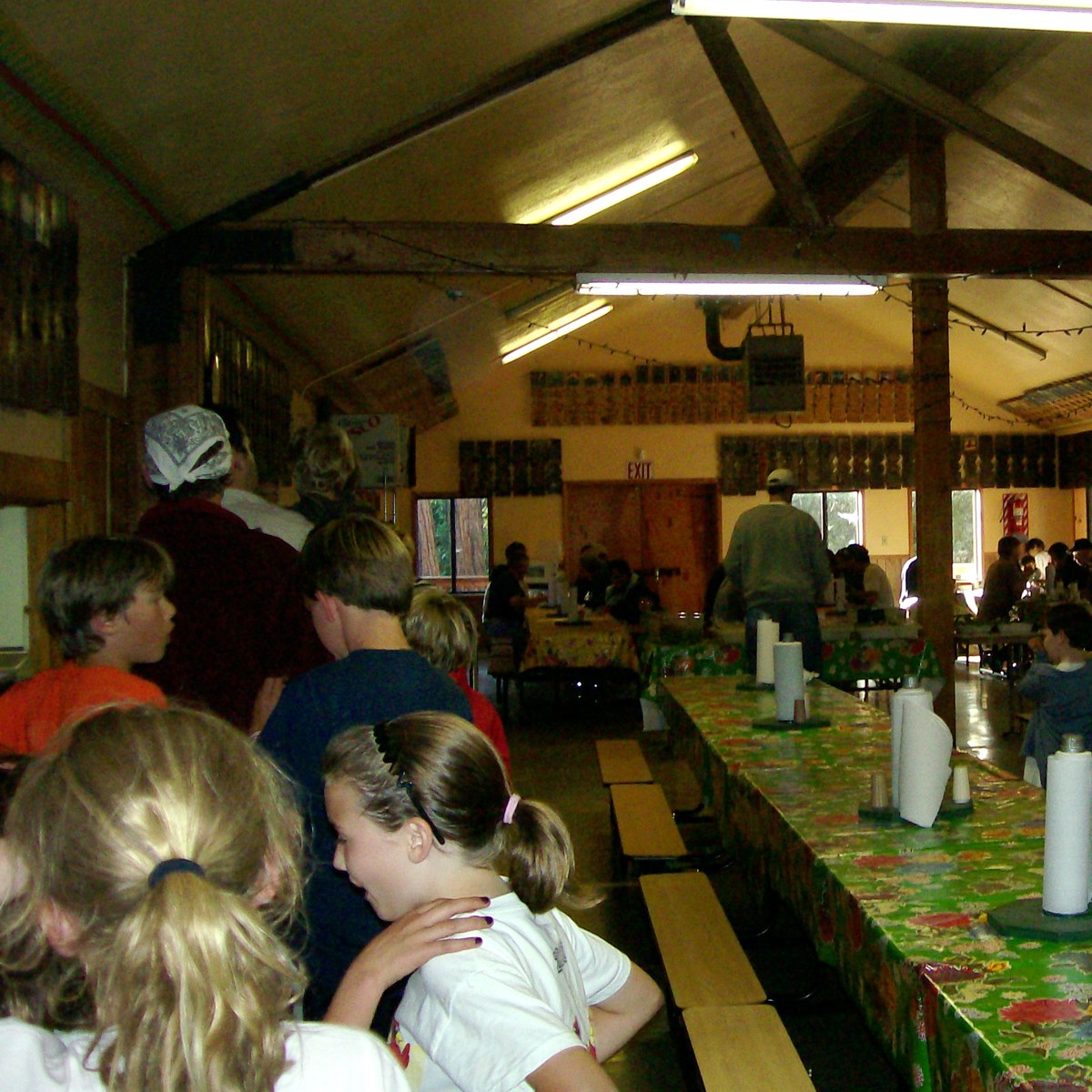 Families queue for a meal in the camp dining hall during Family Camp in 2010.