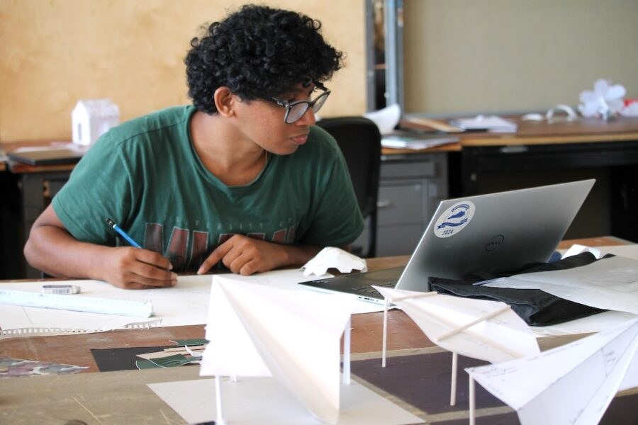 A student drawing and developing a spatial model in the studio