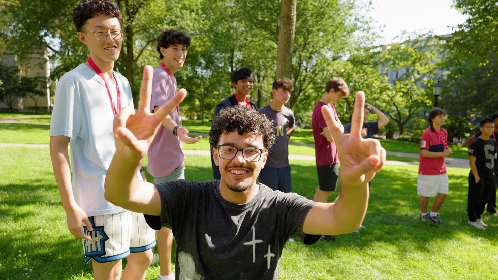 Brown Pre-College students taking part in a group activity on a campus lawn