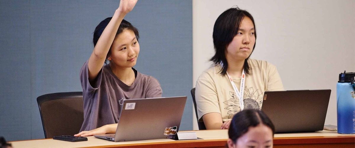 A student raising her hand during class