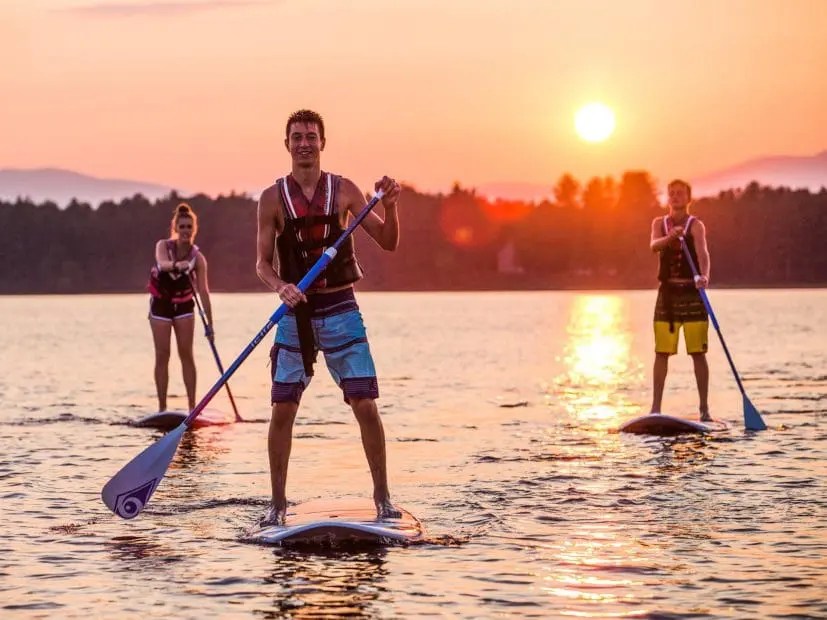 Stand-up paddleboarding at sunset