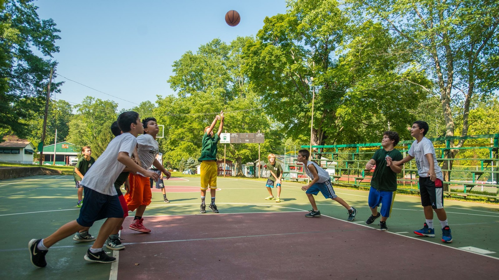 Campers playing basketball outdoors