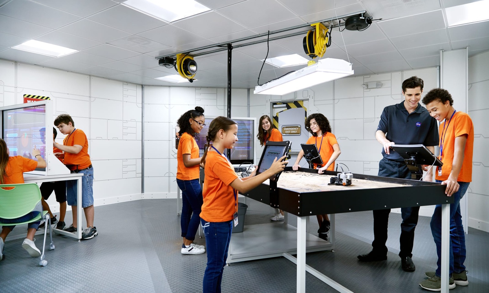 Students using tablets in a visitor-complex education space