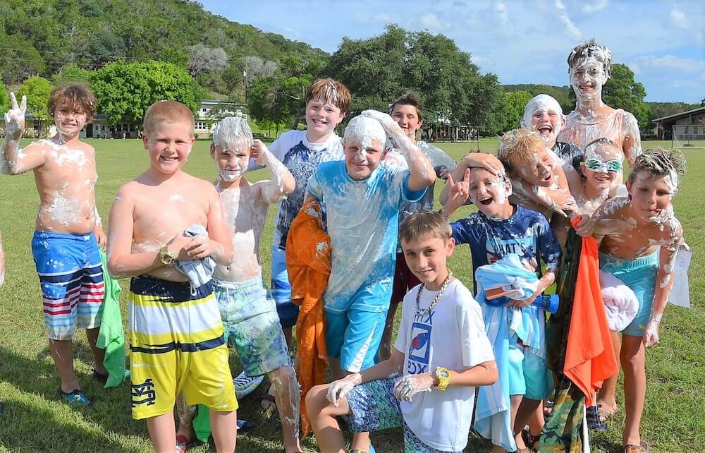 Campers take part in a foam activity on the lawn