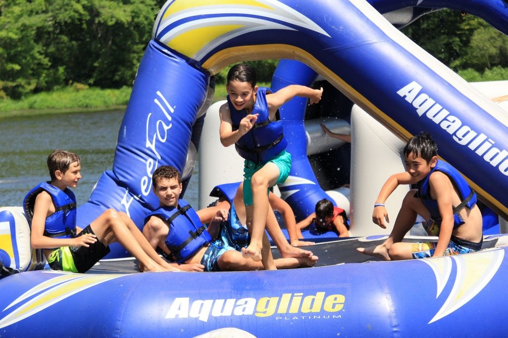 Campers on inflatable lake equipment