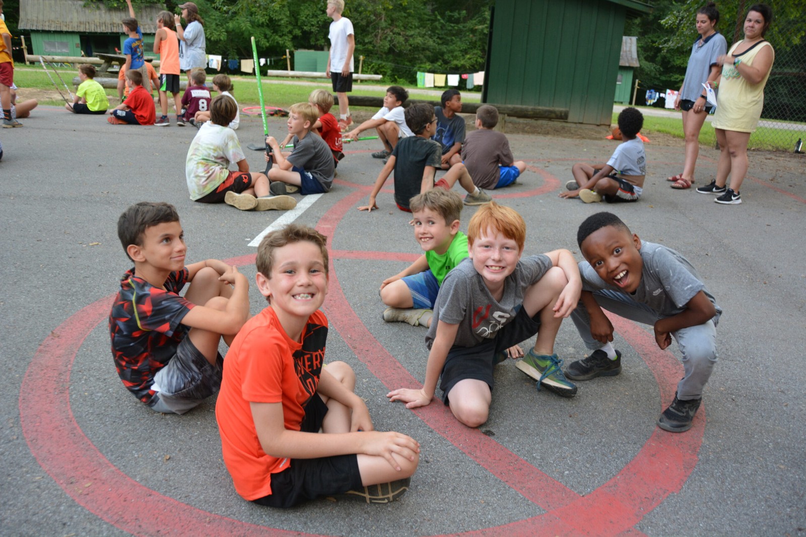 Campers take part in a group activity on an outdoor court