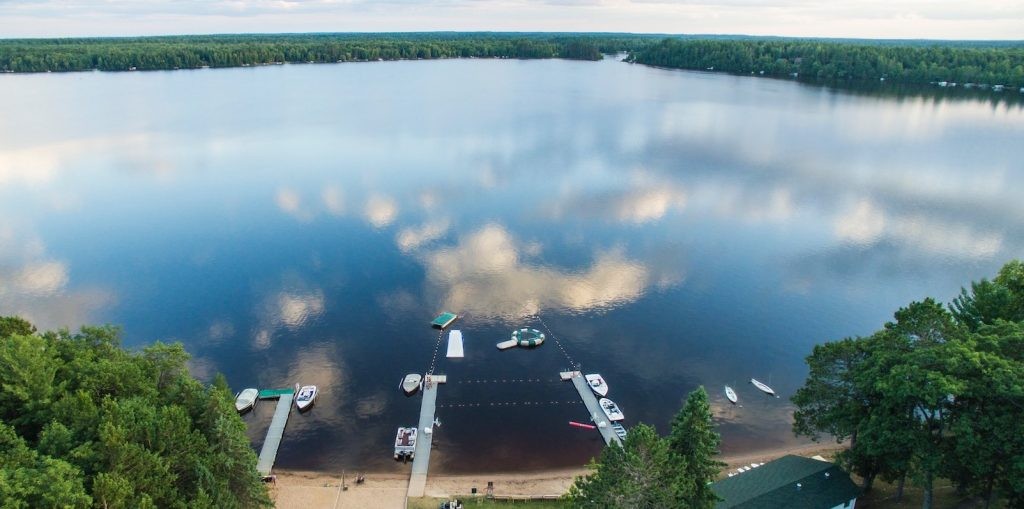 An aerial view of the camp waterfront docks and lake