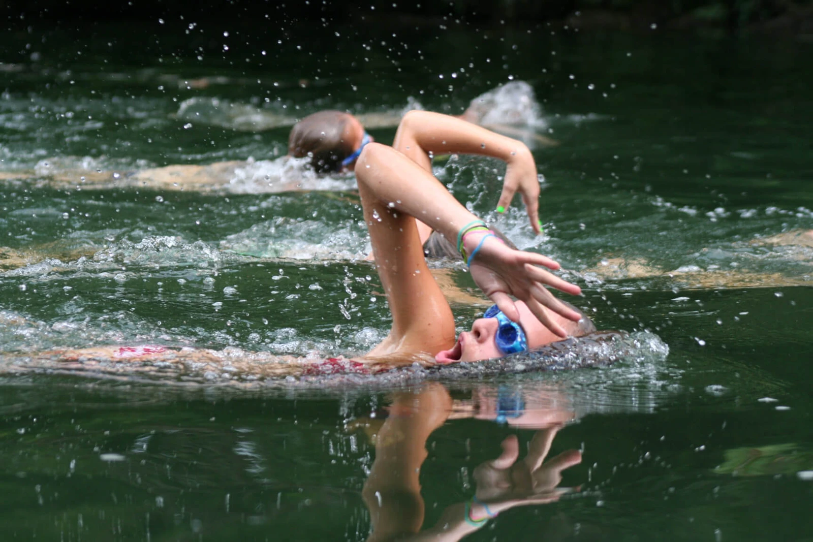 Campers practice swimming in natural water