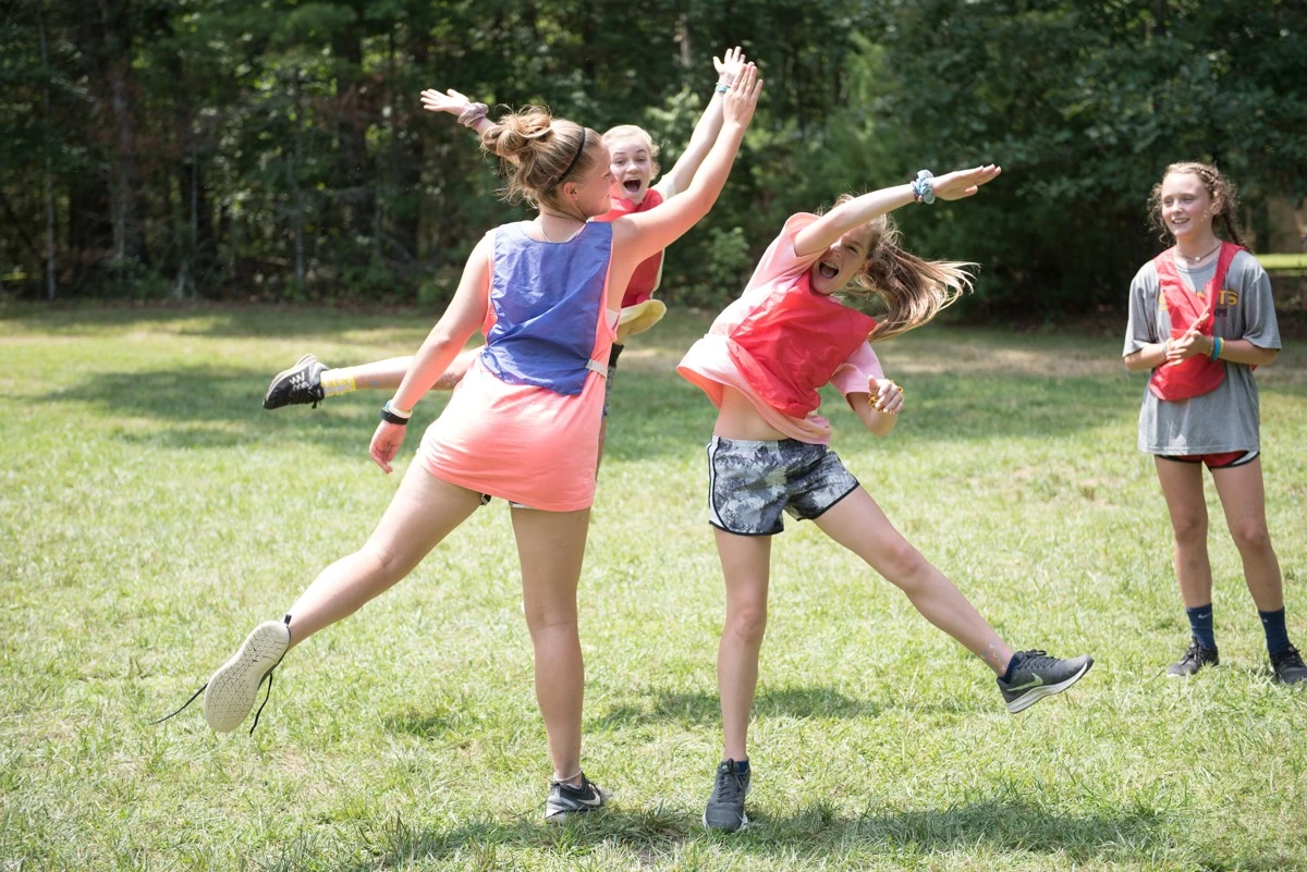 Campers take part in a group game on the lawn
