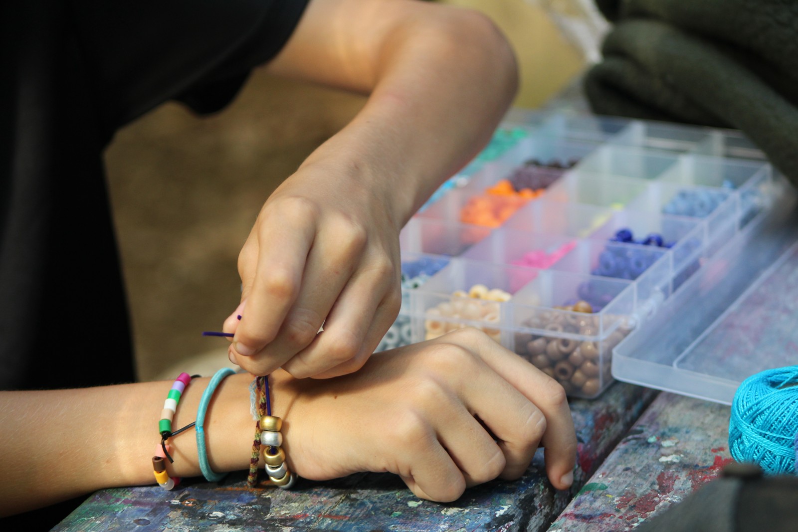 Campers making beaded crafts