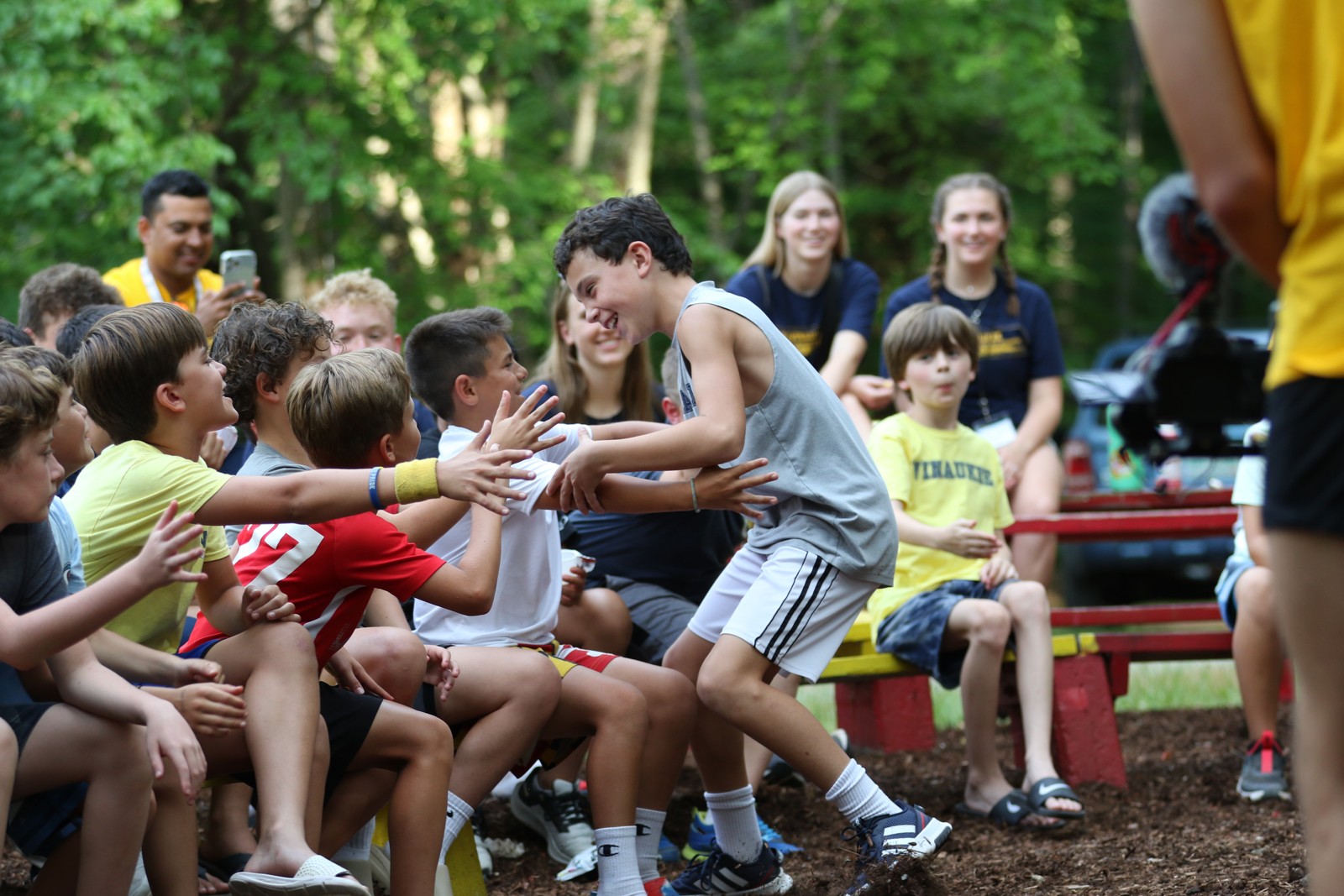 Campers exchanging high-fives with a staff member