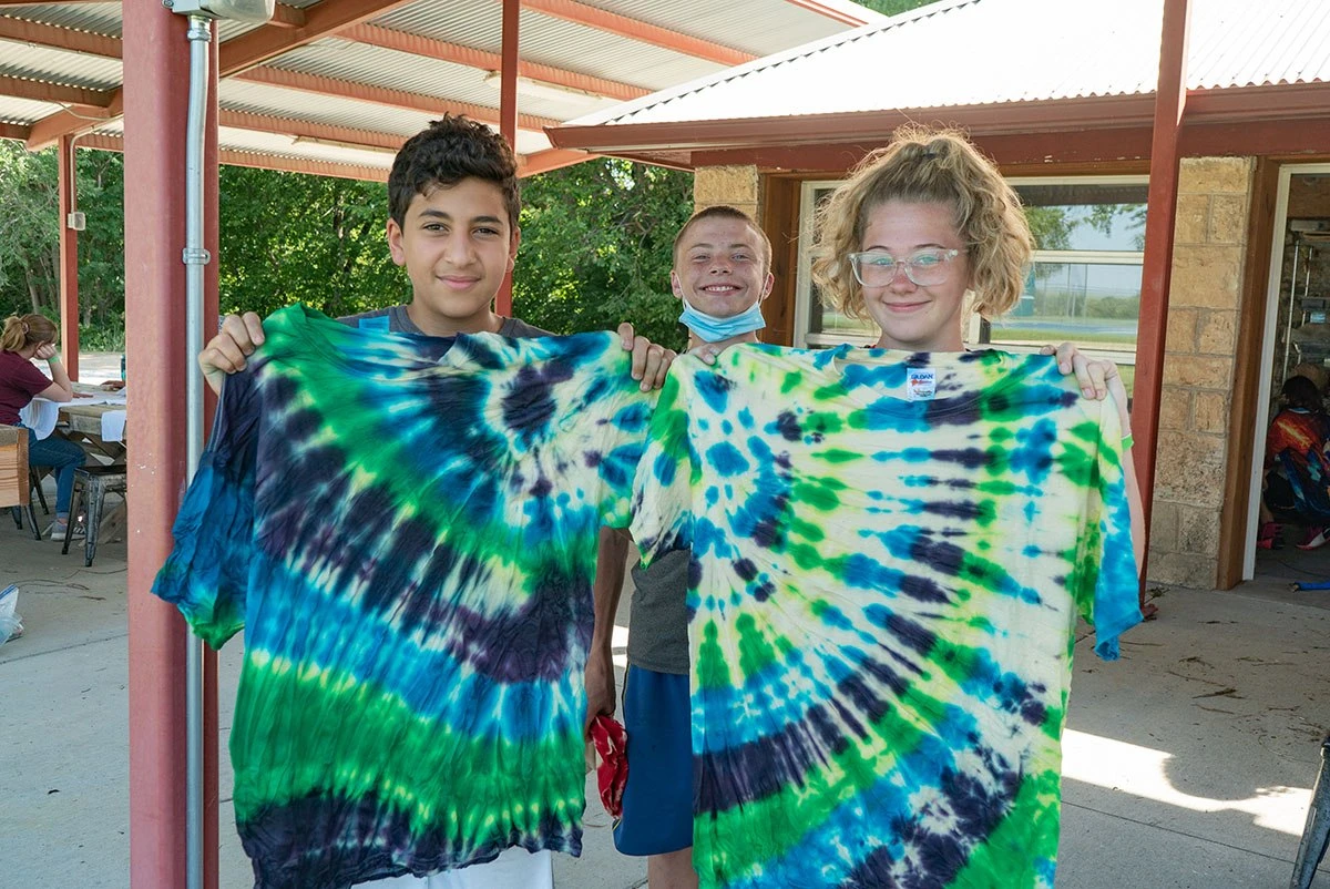 Campers show their tie-dyed shirts