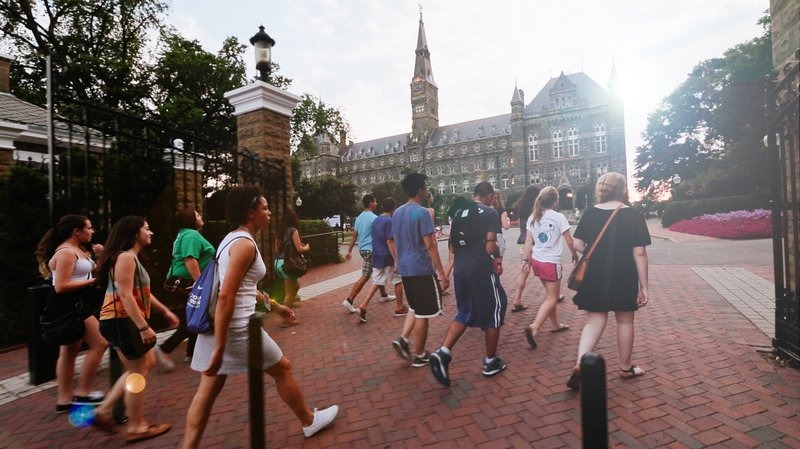 Summer students walking toward Healy Hall