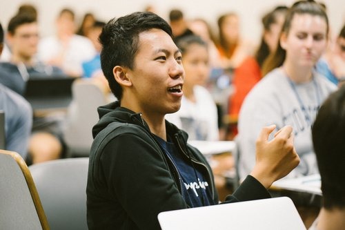 A student speaking in a Georgetown University lecture hall