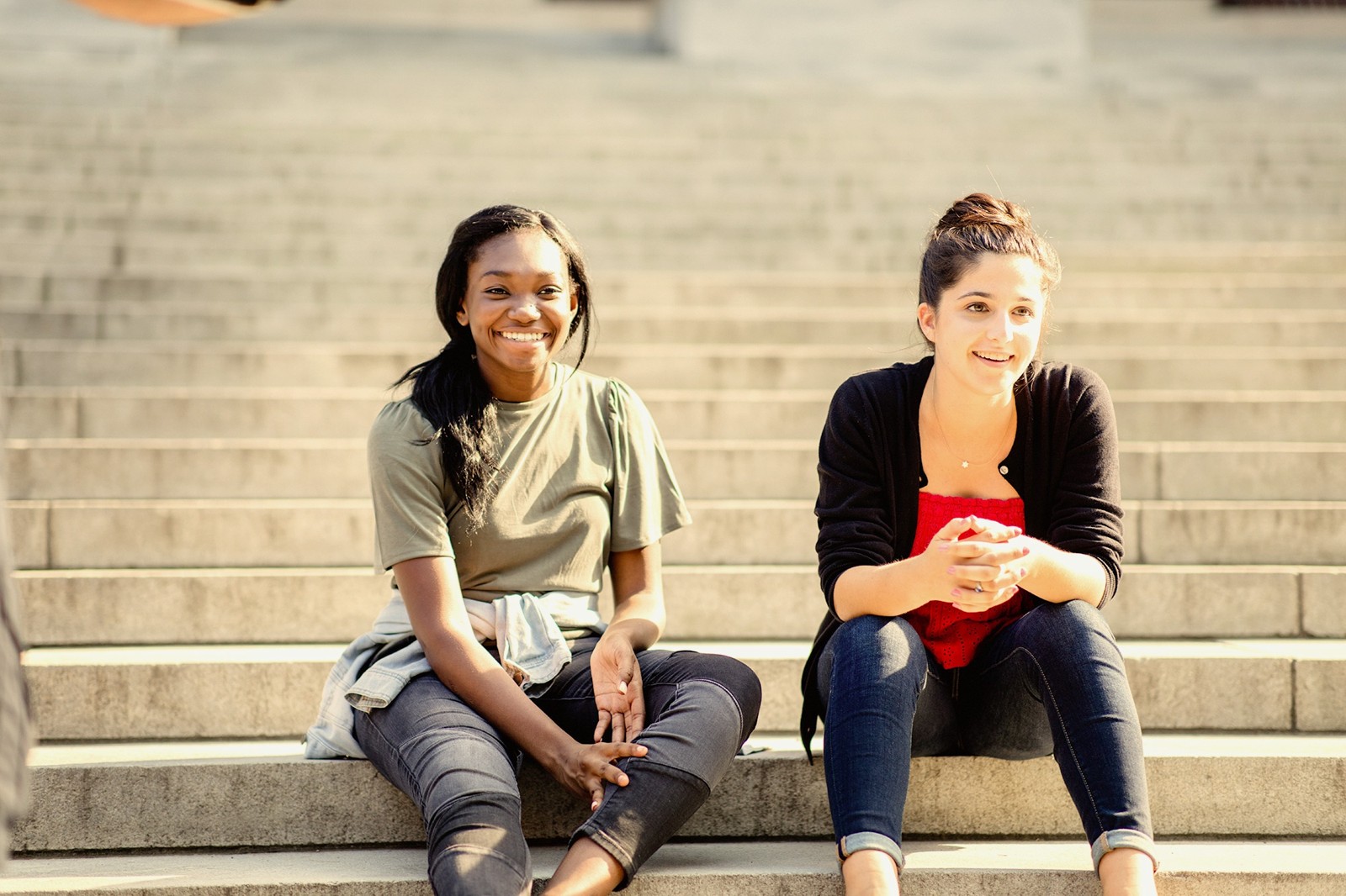 Students taking a break on campus library steps