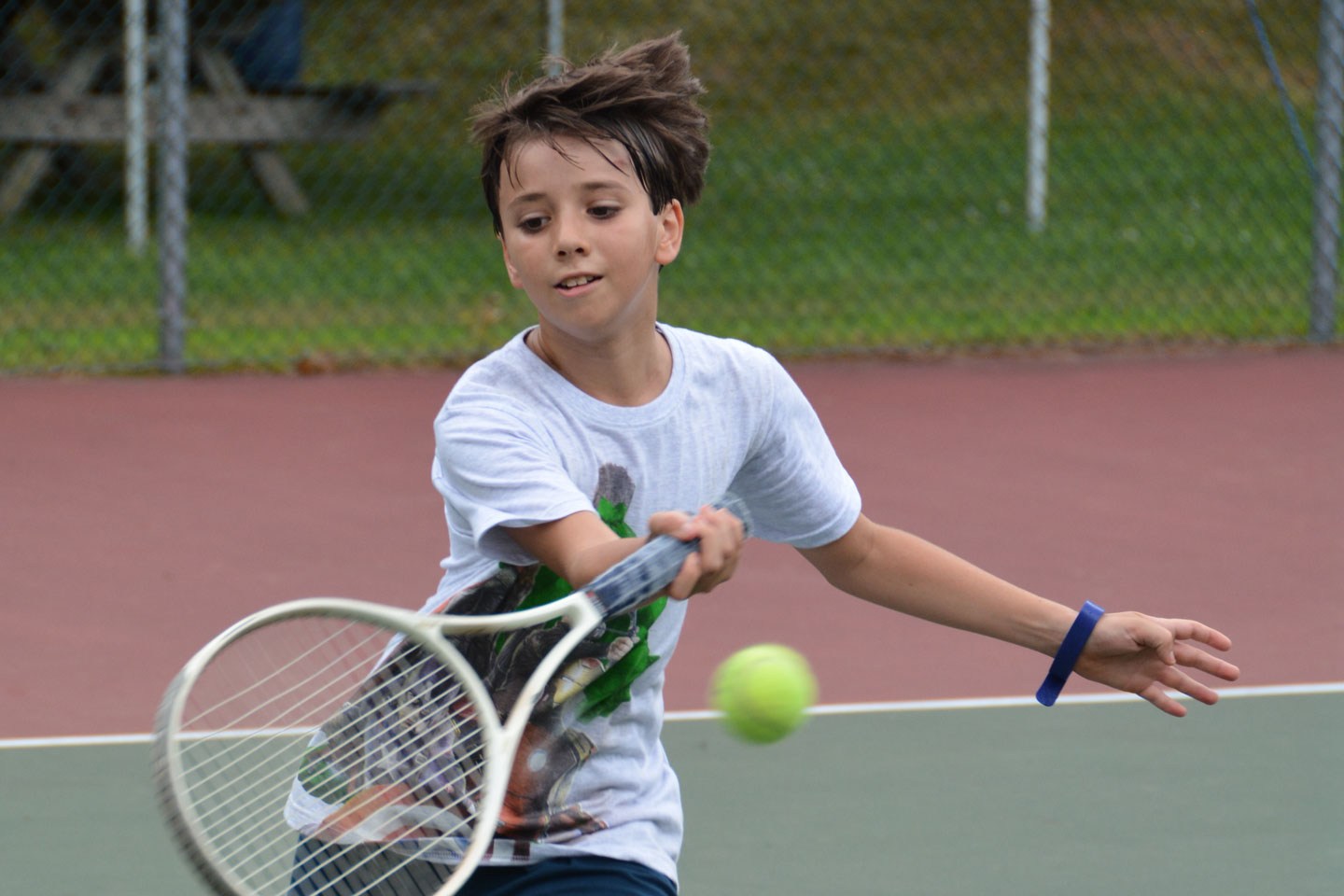 A camper practicing tennis