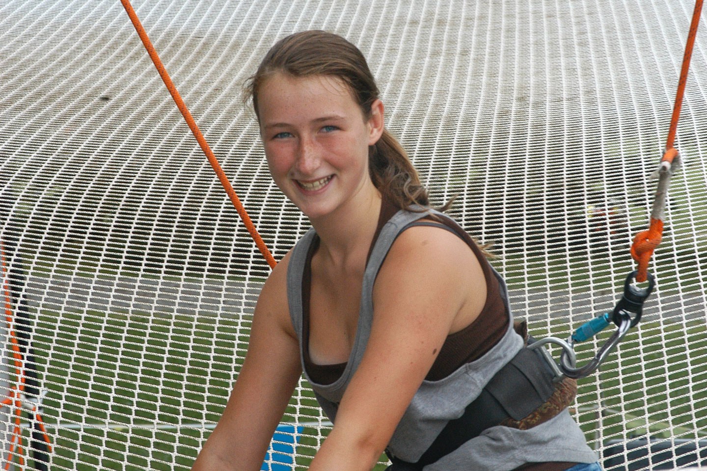 A camper at the trapeze equipment