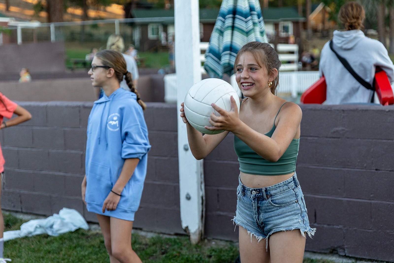 Campers play a ball game outdoors