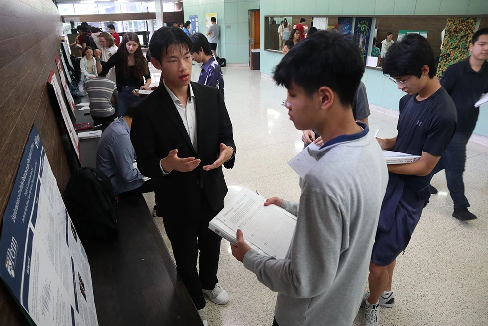 Students discuss their work at a project presentation