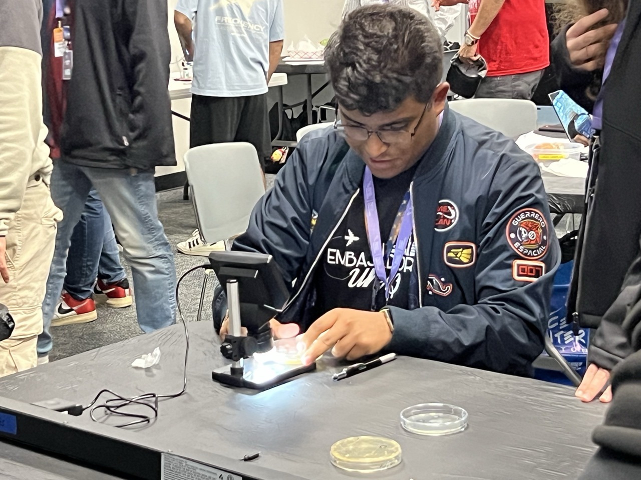A Space Center U student examining a sample through a microscope