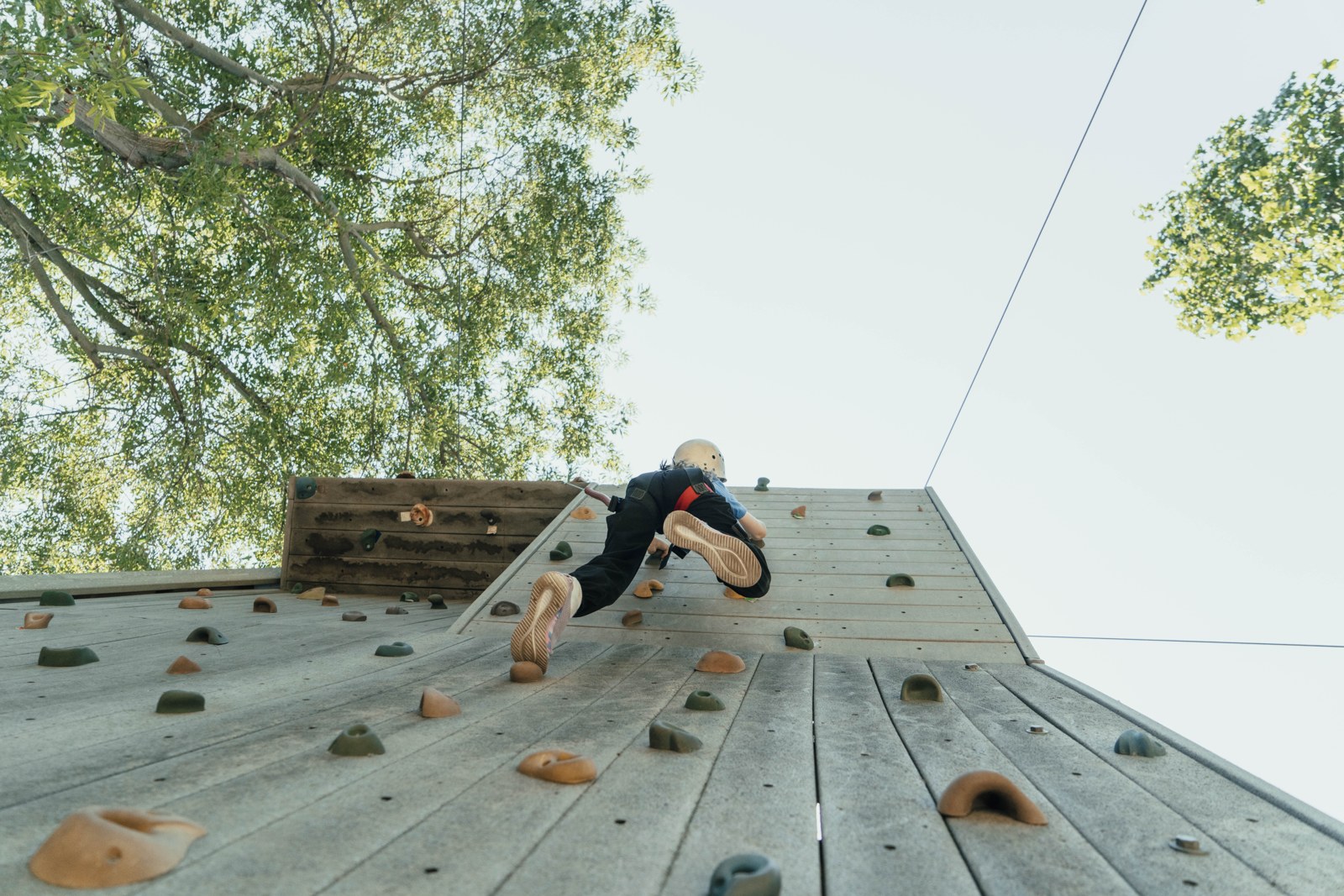 A camper climbs the rock wall